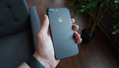 Hand holding a black smartphone, illustrating a digital arrest scam call