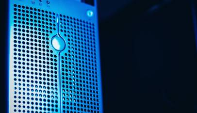 Rows of server racks with blue lights inside a modern AI data centre